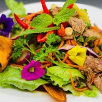 Thai Salad · Mint, onions, carrots, cilantro and thai style lime vinaigrette dressing.