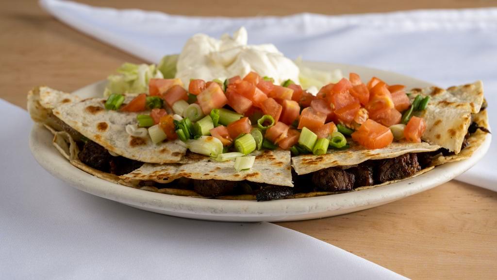 Steak Quesadilla  · Includes bell peppers, mushrooms, onions, avocado, and cheese.