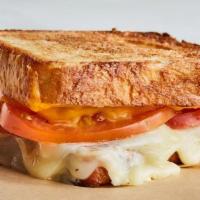 Adult Grilled Cheese · A classic on pain de mie. Double cheese with tomato.