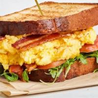 Paradise Egg Sandwich · Popular Item. . Scrambled egg, cheddar, tomato, bacon, arugula on pain de mie or english muf...