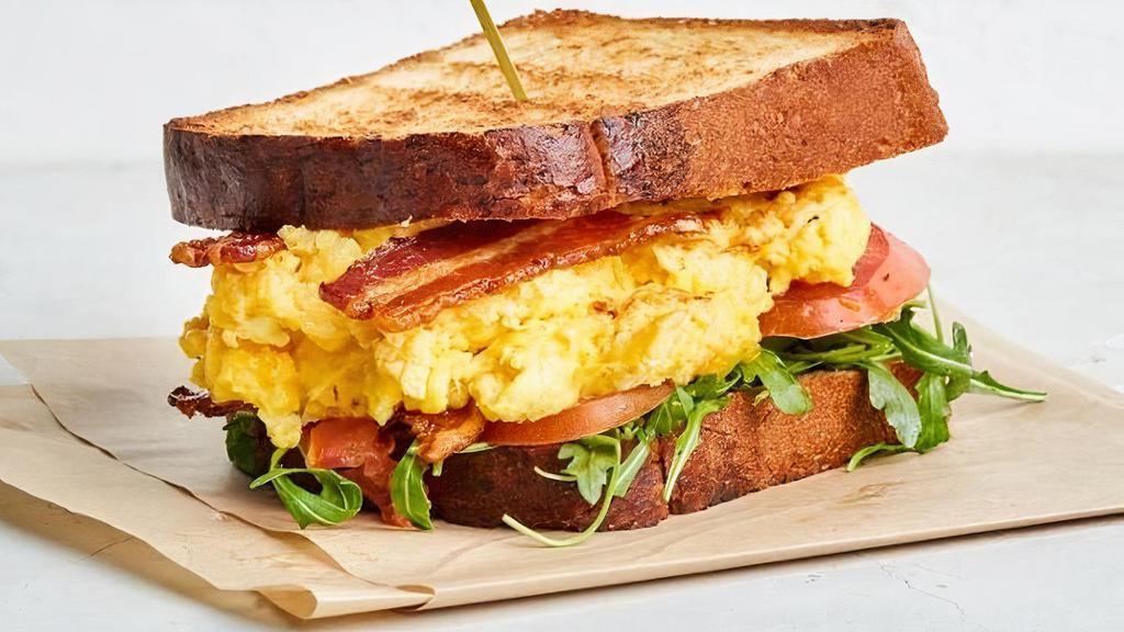 Paradise Egg Sandwich · Popular Item. . Scrambled egg, cheddar, tomato, bacon, arugula on pain de mie or english muffin w/black pepper & garlic aioli