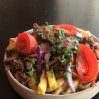 Peruvian Loaded Fries · Sirloin steak with stewed tomatoes, red onions and a little Asian soy tanginess.