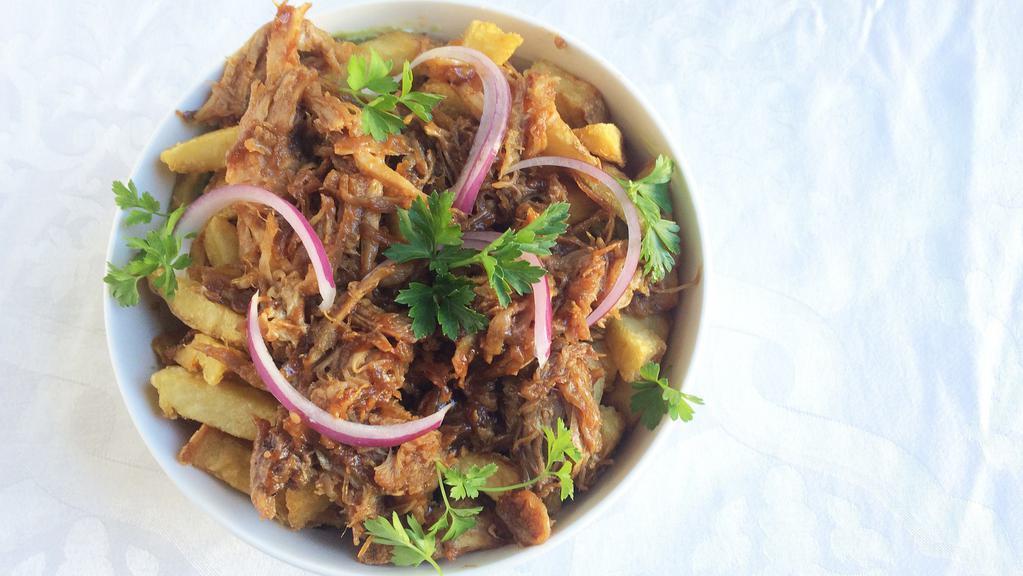 Braised Pulled Pork Loaded Fries · Low and slow pulled pork on top of BBQ smothered Fritz.