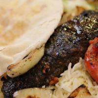 Kefta Kabob · Ground lamb and beef, parsley, and onion with our homemade seasoning on a skewer.