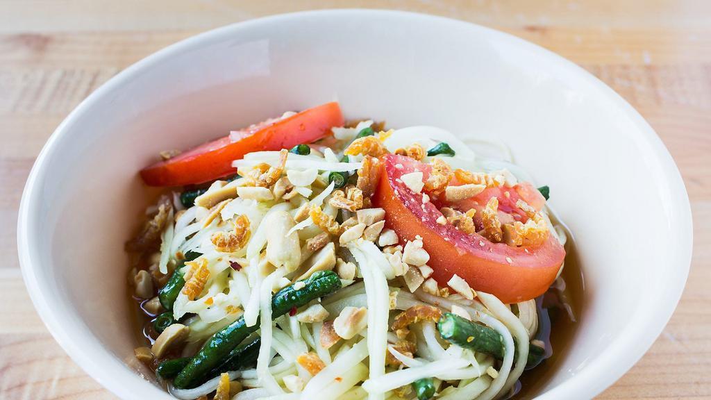 Thai Papaya Salad (Som Tum Thai) · Mildly spiced. A quintessential dish of Thai food: green papaya pounded with dried shrimp, palm sugar, tomatoes, fish sauce, chilies and lime, topped with crushed peanuts.