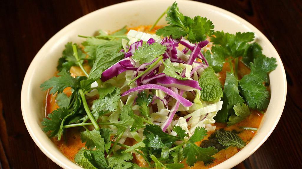 Red Curry Rice Vermicelli Noodles (Khao Poon Nahm Prik) · Laotian noodle dish of rice vermicelli noodles in a spicy coconut milk curry broth with bamboo shoots. Spiced with our home-made red curry paste and enriched with chicken broth, finished with bean sprouts, shaved cabbage and herbs.