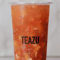 TuttiFrutti · Peach + Passionfruit + Strawberry Green Tea topped w/ Peach Bits, Strawberry Bits, Lychee Je...