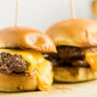 (2) Angus Chuck Burger Sliders · Brioche buns, American Cheese, caramelized onions, pickles.