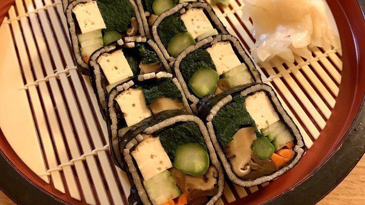 Soba Sushi · A roll made up of buckwheat noodles (in place of sushi rice), spinach, assuage tofu, asparagus, cucumber, pickled burdock, and seasoned kampyo gourd and shiitake. Served with a soda dipping sauce.