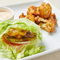 Paleo Lettuce Wrapped Burger · Lettuce wrapped fresh grilled seasoned beef patty, tomato, onion and pickles. Served with fr...