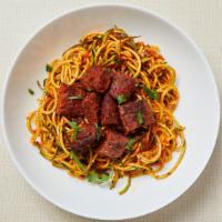 Paleo Meatball Marinara Zoodle · Pan roasted zucchini noodles served with homemade tomato sauce and spicy lamb meatballs. Glu...