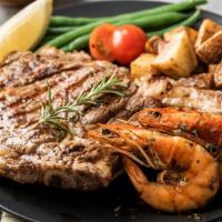 Ribeye Steak with Prawns · A mouthwatering 10 oz Grilled Ribeye Steak seasoned to perfection with 4 prawns. Served with...