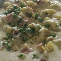 Tortellini Mona Lisa · Our meat tortellini prepared in our chef's special Romano cream sauce with sweet peas, and I...