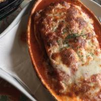 Sicilian Eggplant · Fresh roasted eggplant seasoned with onion and herbs in a spicy red sauce.