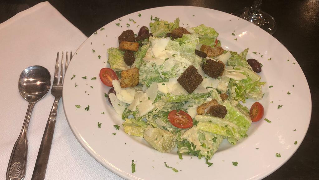 Caesar · Romaine hearts in a classic caesar dressing with Parmesan cheese, croutons and anchovies.