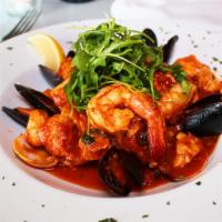 Pescatore · Clams, mussels, tiger shrimp, salmon and halibut in a tomato lobster sauce over risotto.