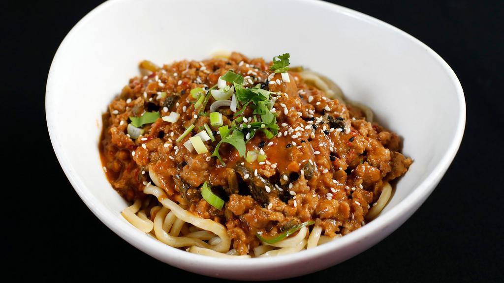 Szechwan Pork Noodles · Minced pork, salted greens in a spicy sesame garlic paste topped with green onions, cilantro, and sesame seeds. Spicy.
