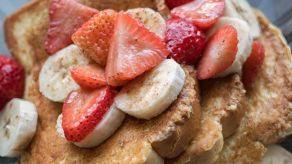 A7 Strawberry & Banana Pancakes · Two buttermilk pancakes topped with fresh strawberries, bananas & sprinkled with powdered sugar.