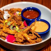 Classic Fried Calamari · lightly battered and fried Pacific catch squid, served with traditional cocktail marinara sa...