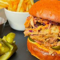 Pulled Pork Sandwich · house-smoked pulled pork, coleslaw, pickle, jalapeno, and chipotle mayo on brioche bun and f...