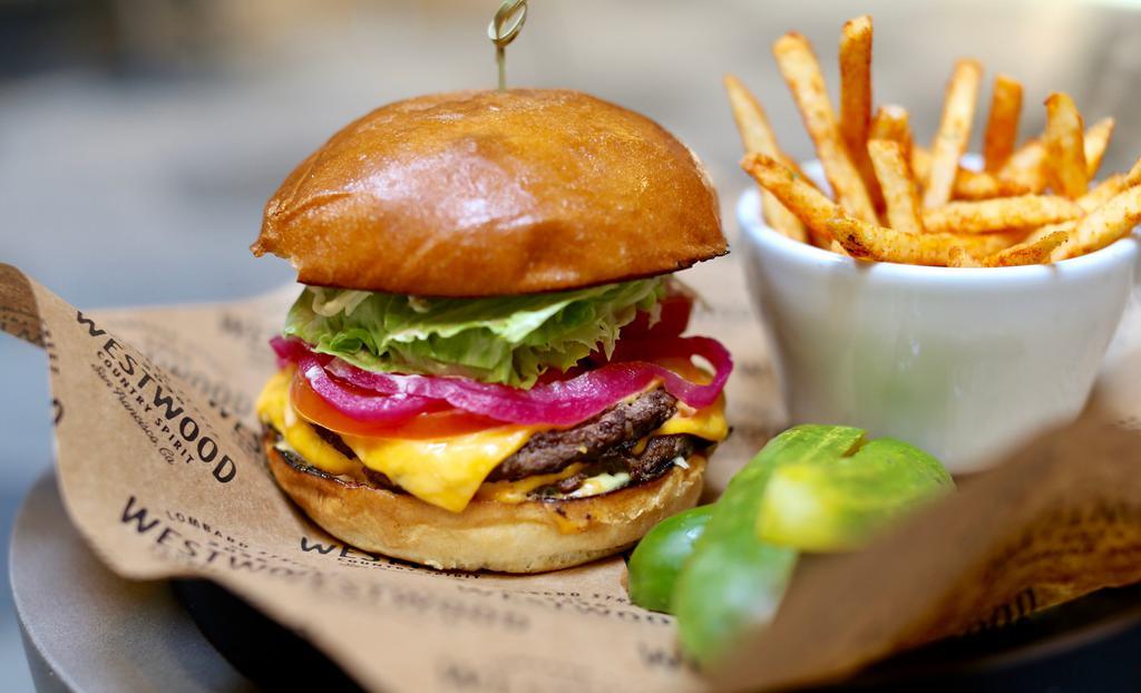 The Westwood Burger · Double patty house blend beef, cooked true, panorama brioche bun, American cheese, sweet pickles, lettuce, tomatoes, chefs secret sauce and french fries.