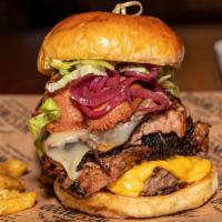 The Texas Size Burger · 4 oz Angus beef patty, 2 oz of our famous 14-hours smoked brisket, grilled hotlink, lettuce,...