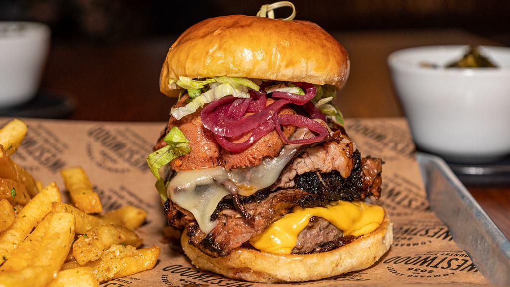 The Texas Size Burger · 4 oz Angus beef patty, 2 oz of our famous 14-hours smoked brisket, grilled hotlink, lettuce, pickled onions, homemade bbq sauce, American and pepper jack cheese, served with garlic fries