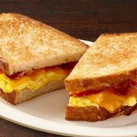 Breakfast Sandwich · Toasted sourdough filled with lettuce, tomatoes, scrambled eggs, cheddar cheese and turkey b...