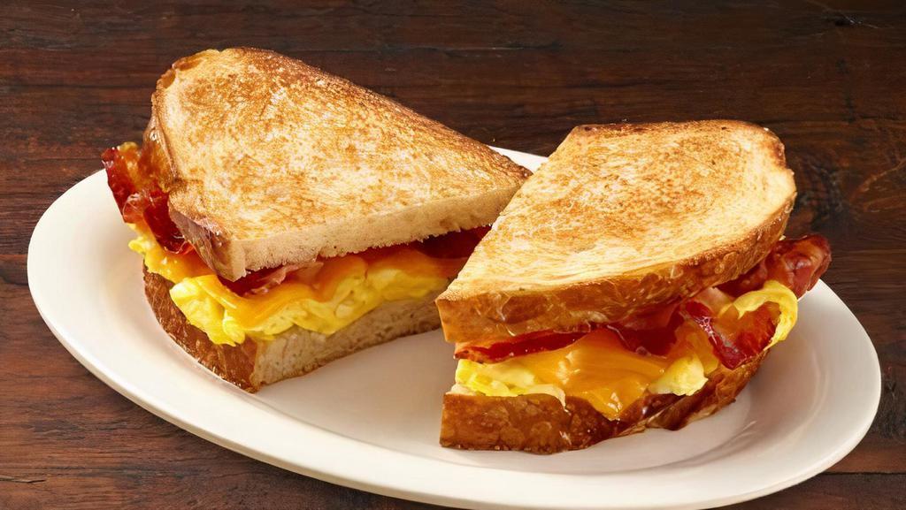 Breakfast Sandwich · Toasted sourdough filled with lettuce, tomatoes, scrambled eggs, cheddar cheese and turkey bacon.