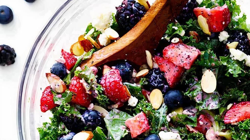 Kale Berry Chicken Salad · Grilled chicken breast served over a bed of kale, topped with blueberries & strawberries, pecans and feta cheese served with a berry vinaigrette.