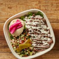 Beef Fatteh Bowl · Rice or fresh greens, beef shawarma, hummus, tahini sauce, Greek pico, mixed pickles.