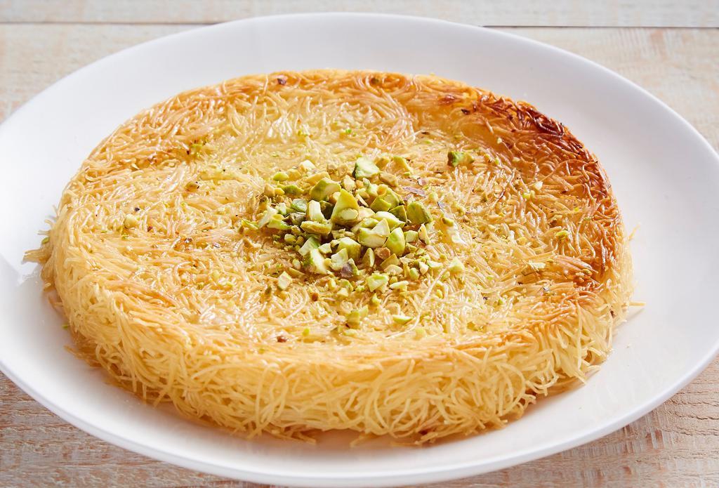 Kanafeh · Layered with shredded sweet crispy filo, string cheese and topped with crushed pistachios - freshly baked to order.