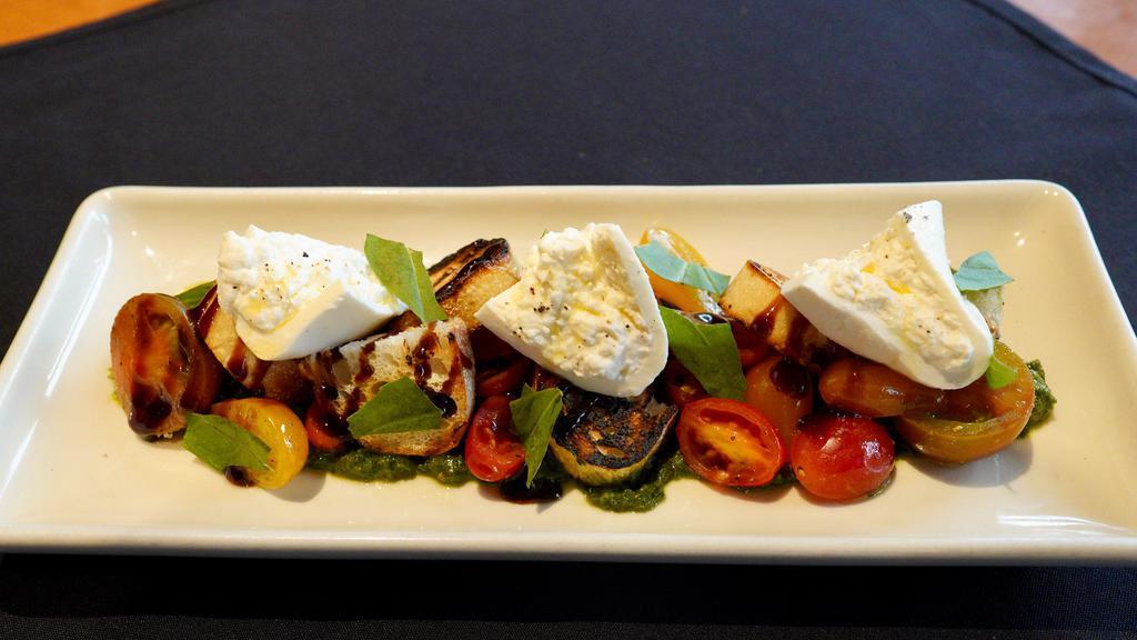 Heirloom Tomatoes and Burrata · Grilled sourdough croutons, extra-virgin olive oil, balsamic vinegar, basil pesto.  470 cal.