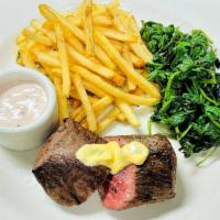 Chef's Featured Steak · Organic baby spinach, roasted fingerling potatoes, calabrian chile butter.