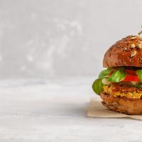 Vegan Veggie Patty Burger · Mouth watering veggie patty topped with fresh tomatoes and caramelized onions.