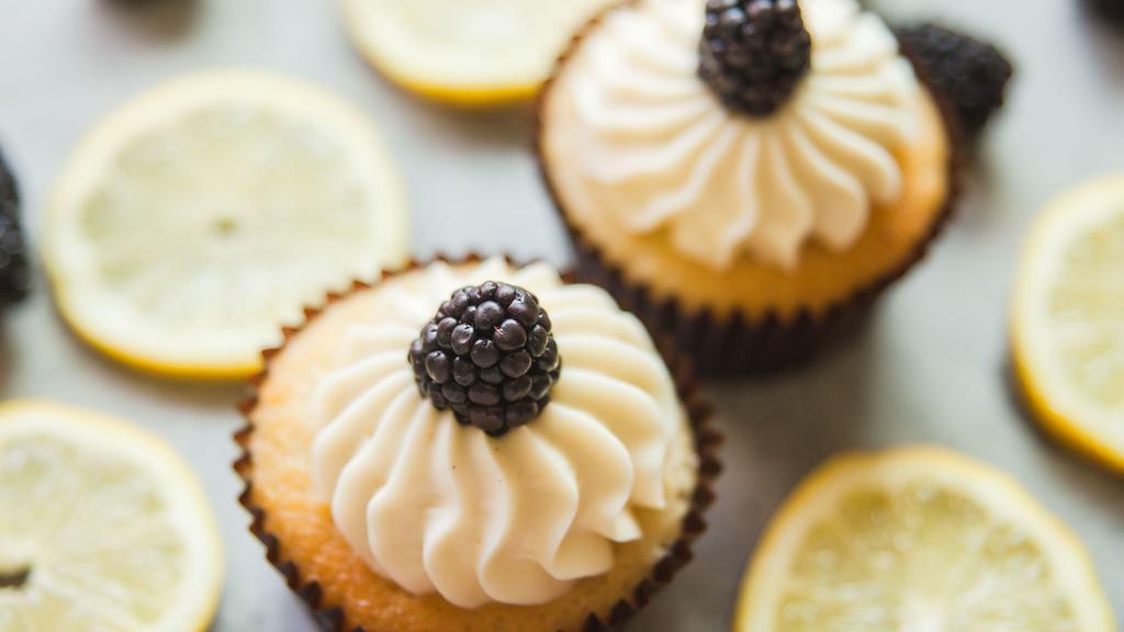 GLUTEN FREE Lemon Blackberry · Lemon Cake with blackberries baked in. Whipped Cream frosting and a blackberry garnish.