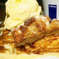 Our Famous Apple Pie & Ice Cream Combo · Homemade apple pie with vanilla ice cream scoop.