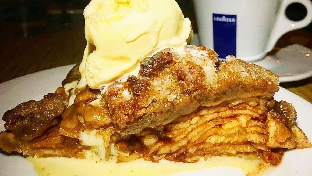 Our Famous Apple Pie & Ice Cream Combo · Homemade apple pie with vanilla ice cream scoop.