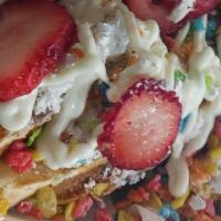 9. Fruity Pebble Dessert Waffles · Fruity pebble waffles golden brown and topped with fruity pebbles powdered sugar  fresh stra...