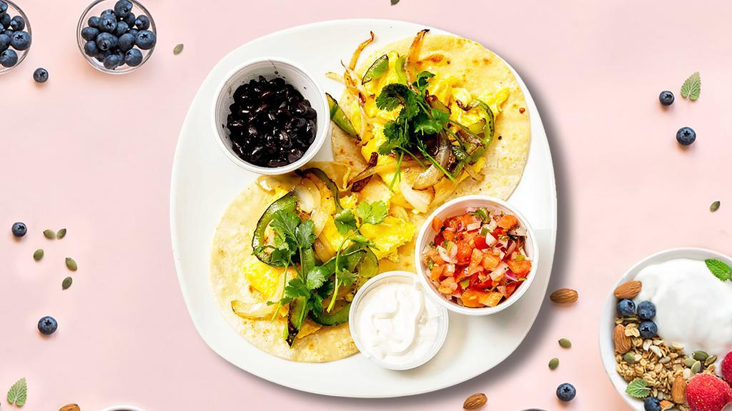 Jolly Rancheros (Huevos) · Lightly fried eggs served on a warm tortilla and topped with salsa, tomatoes, chili peppers, onions, cilantro, guacamole, black beans, and sour cream.