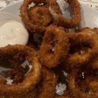Onion Rings · Thick onion slices, beer battered and drizzled with gorgonzola dressing.