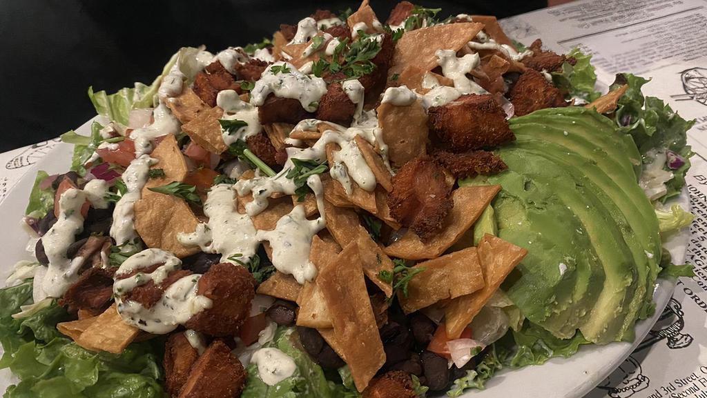 Pepe Salad · Crispy lettuce, pico de gallo, chopped tortillas, black beans, and deep fried chicken nuggets, with your choice of dressing, drizzled with lime-jalapeno cream sauce.