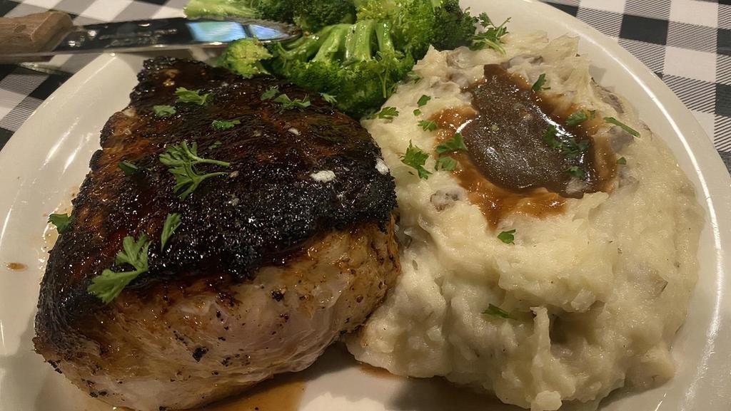 Thick Cut Pork Chop · 2 inches of pork heaven. Lightly seasoned then seared in a cast iron pan, transferred to a broiler and finally tented to a perfectly moist 145°. Served with seasonal veggies and onion gravy covered mashed potatoes.