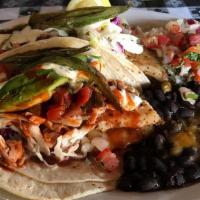 Fish Tacos · Two tacos; sauteed tilapia fillets covered in dressed slaw, pico de gallo, avocado slices an...