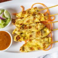 Satay Skewers · Choice of tofu, chicken or prawns marinated with Thai herbs; served with peanut sauce and cu...