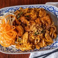 Pad Thai · Stir-fried Thai rice noodles with chicken and prawns, egg, tofu, ground peanut, onions and b...