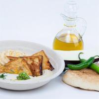 Hummus Tel Aviv · Hummus topped with Crispy eggplant, overnight egg, tahini, olive oil, cumin and freshley cho...