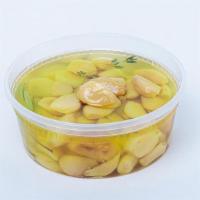 Garlic Confit · Whole garlic cloves and fresh herbs slowly cooked in olive oil.