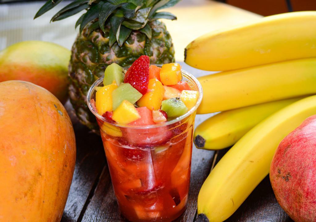 Escamocha · Fresh diced fruit in a cup with a spicy-sour juice that pairs perfectly with the fruit.