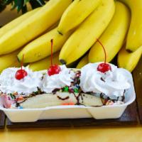 Banana Split · A split banana covered with three scoops of ice cream, topped with fudge drizzle, whipped cr...